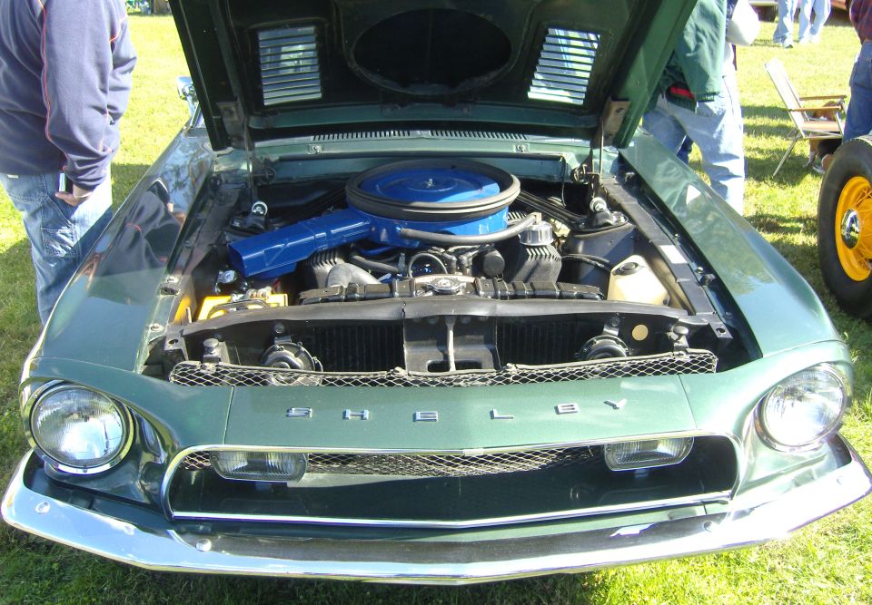 Green 1967 Shelby GT500 with hood open, showing engine and blue air cleaner