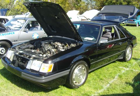 2007 Ford Mustang - A black 1987 Ford Mustang hatchback is displayed with its hood and trunk open, revealing the engine and interior.
