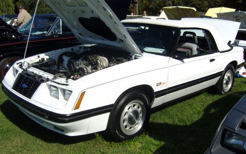 2007 Ford Mustang - A white 1987 Ford Mustang convertible is displayed with its hood open, showing the engine bay.