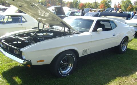 2007 Ford Mustang - A white 1971 Ford Mustang Mach 1 is displayed with its hood open at an outdoor car show.
