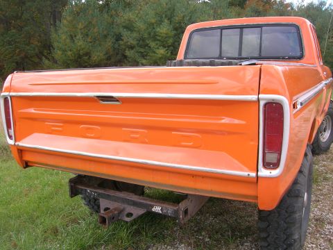 1975 Ford F-250 - Rear view of an orange 1975 Ford F-250 pickup truck with a trailer hitch installed.