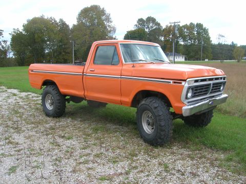 1975 Ford F-250 - This orange 1975 Ford F-250 pickup truck is shown from a three-quarter front angle.