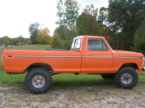 1975 Ford F-250 - Side profile of a lifted 1975 Ford F-250 pickup truck with orange paint.