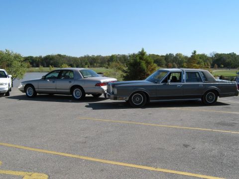 2000 Mercury Grand Marquis - Two sedans, a Lincoln Town Car and a Mercury, are parked outdoors on a sunny day.