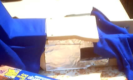 1999 Ford Taurus - A close-up view of what appears to be a car's interior component covered in blue fabric.