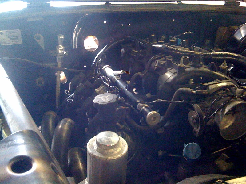 Engine bay with exhaust headers and intake manifold