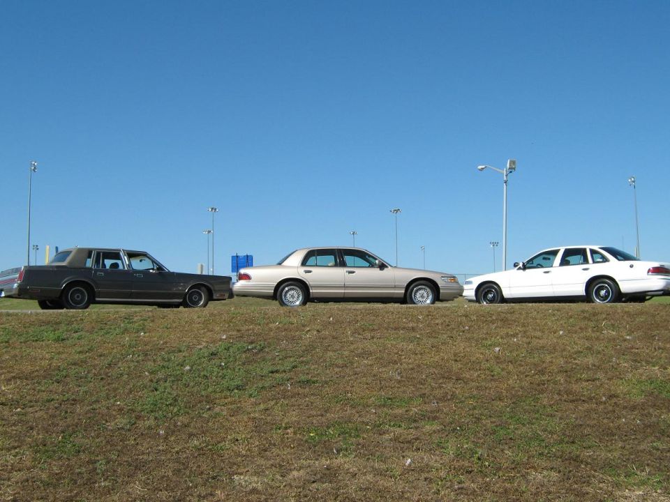 2000 Mercury Grand Marquis parked next to two other sedans