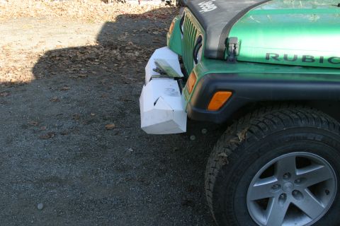 1987 Suzuki Samurai - A green Jeep Wrangler is shown with a custom-built, angular white bumper attached to the front.