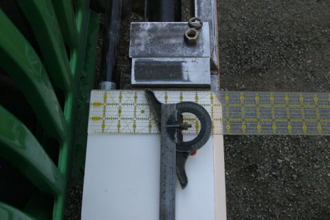 1987 Suzuki Samurai - Measuring tools and metal components are laid out on a surface, with a green structure visible to the left.