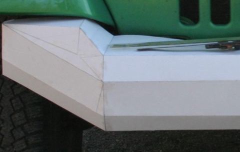 1987 Suzuki Samurai - A custom-built bumper is shown attached to the front of a green vehicle, with a tire visible underneath.