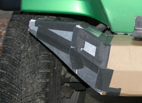 1987 Suzuki Samurai - Custom bumper modification using tape and metal sheeting is attached to the vehicle's fender.
