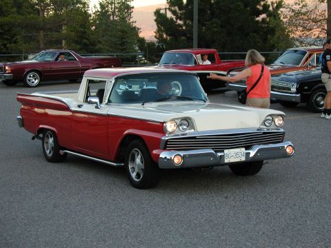 1967 Ford Ranchero - A two-tone 1959 Ford Fairlane 500 Skyliner is parked with other vehicles in the background.