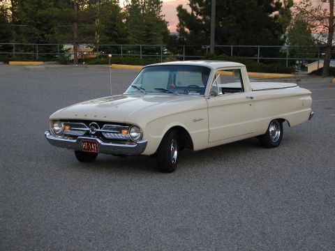 1967 Ford Ranchero - Cream 1967 Ford Ranchero pickup truck parked in a lot, showing its distinctive body style.
