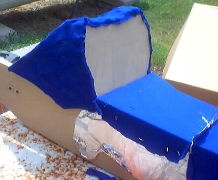 1999 Ford Taurus - A car seat is being reupholstered with blue fabric and foam padding.