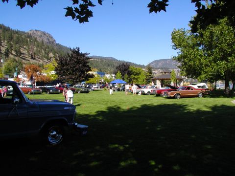 1967 Ford Ranchero - An outdoor car show is taking place on a sunny day with several vehicles displayed on a grassy field.