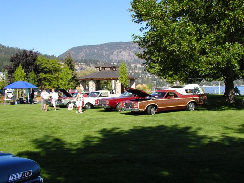 1967 Ford Ranchero - Several classic vehicles are displayed on a grassy lawn near a lake and gazebo.