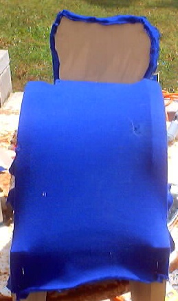 1999 Ford Taurus - This image shows a piece of blue car upholstery, likely from the interior, with text from Supermotors.net visible at the bottom.