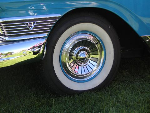 1967 Ford Ranchero - Close-up of a turquoise car's front wheel and fender trim, showing whitewall tire and chrome hubcap.