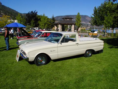 1967 Ford Ranchero - A vintage Ford Falcon Ranchero is displayed at an outdoor event with a scenic background.