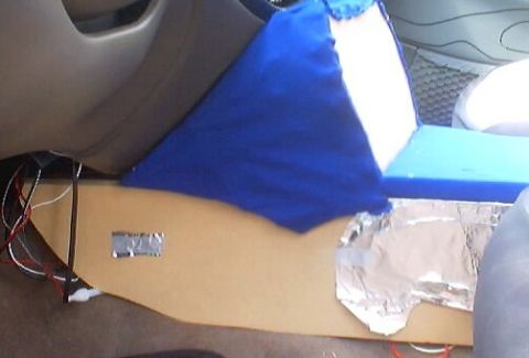 1999 Ford Taurus - Interior modification with exposed wiring and custom paneling, covered by blue fabric.