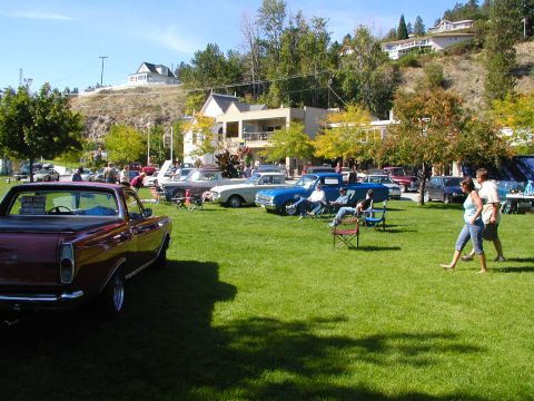 1967 Ford Ranchero - Several classic vehicles are on display at an outdoor event on a sunny day.