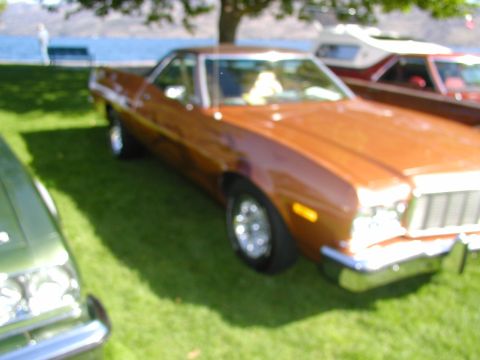 1967 Ford Ranchero - A brown 1977 Ford Ranchero is parked on a grassy area near a body of water.