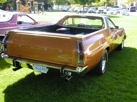 1967 Ford Ranchero - A brown 1972 Ford Ranchero Squire pickup truck is parked on a grassy lawn with other vehicles in the background.