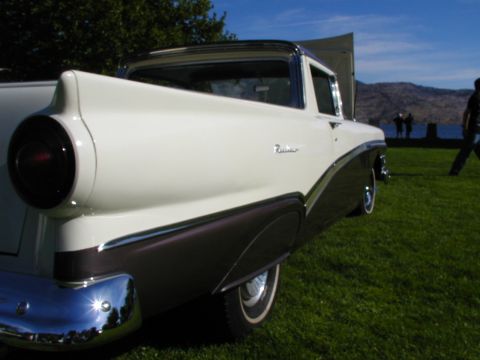 1967 Ford Ranchero - A classic two-tone Ford Ranchero is displayed outdoors with its hood up, against a backdrop of water and hills.