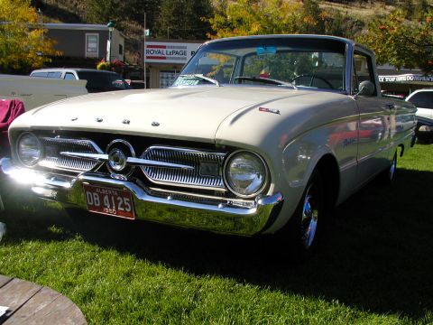 1967 Ford Ranchero - Cream 1960 Ford Falcon Ranchero parked on grass with a building in the background.