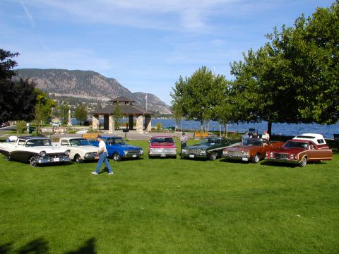 1967 Ford Ranchero - A collection of vintage vehicles are displayed on a sunny day by a waterfront park.