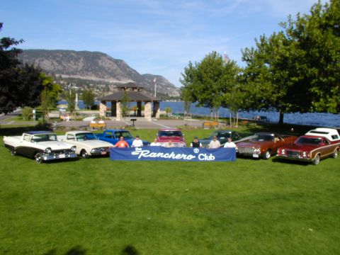 1967 Ford Ranchero - A collection of vehicles, including several Ford Rancheros, gathered for a club event by a lake.