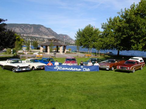 1967 Ford Ranchero - A collection of Ford Rancheros and other vehicles are displayed on a grassy area near a lake, with a banner identifying them as part of the…