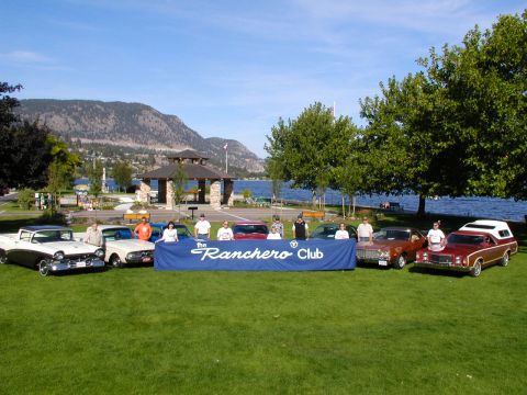 1967 Ford Ranchero - A group of classic vehicles are displayed on a grassy area next to a lake, with a banner for the Ranchero Club.