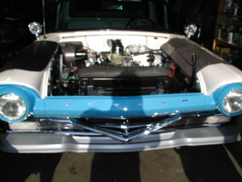 1967 Ford Ranchero - Front view of a 1957 Ford Fairlane 500 with the hood open, revealing the engine.