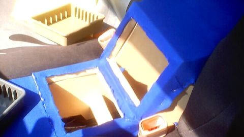 1999 Ford Taurus - A custom-built center console, upholstered in blue fabric, is shown with openings for storage or components.