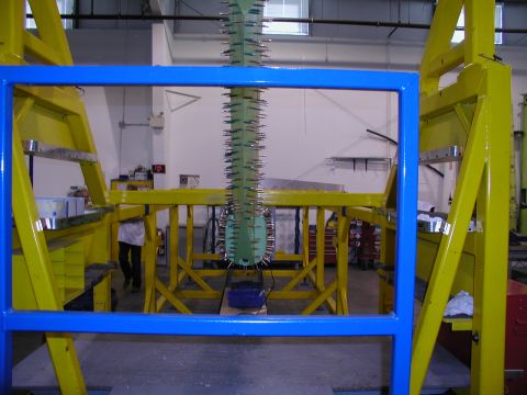 1967 Ford Ranchero - A green component, possibly an aircraft part, is secured in a jig for inspection or assembly.