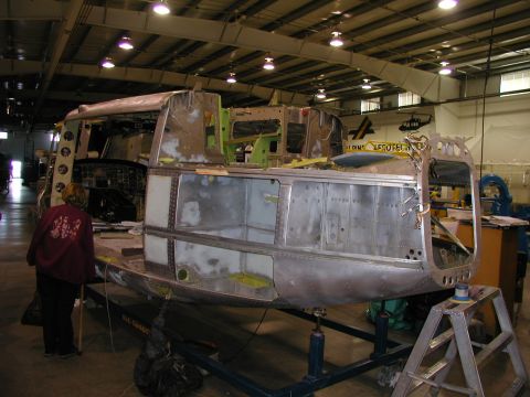 1967 Ford Ranchero - An aircraft fuselage is being worked on in a hangar, showing its internal structure and repair process.