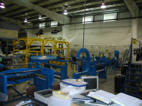 1967 Ford Ranchero - Interior of a factory with various industrial machines and equipment, including metal benders and shears.