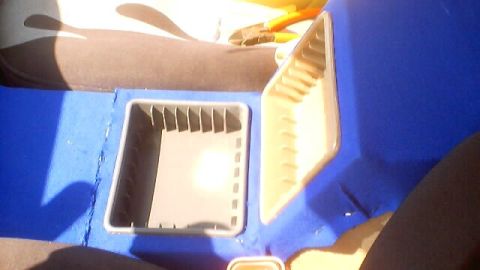 1999 Ford Taurus - Interior view of a vehicle's center console with custom blue upholstery and storage bins.