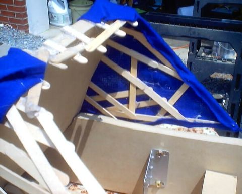 1999 Ford Taurus - A structure covered with a blue tarp, built with a wooden frame, is visible with a 'SUPERMOTORS' watermark in the corner.
