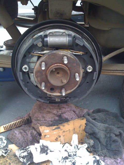 1989 Toyota Pickup/SR5 - Close-up view of a vehicle's rear drum brake assembly, showing the brake shoes and wheel cylinder.