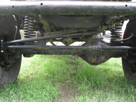 1973 Ford Bronco - The photo shows the undercarriage of a vehicle, focusing on the suspension and steering systems.