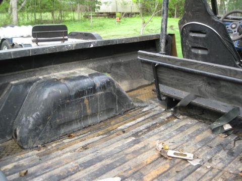 1973 Ford Bronco - Interior view of a utility vehicle's cargo bed, showing the wheel wells and seating.