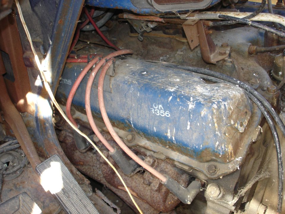 Blue engine valve cover with white text 'OK 3356' and spark plug wires