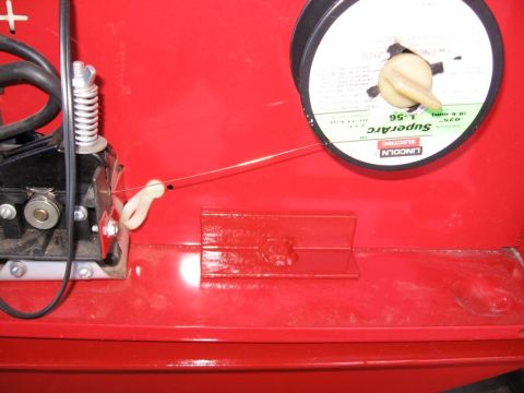 1995 Ford F-150 - Close-up of a Lincoln Electric SuperArc wire spool and feeder mechanism inside a red welding machine.