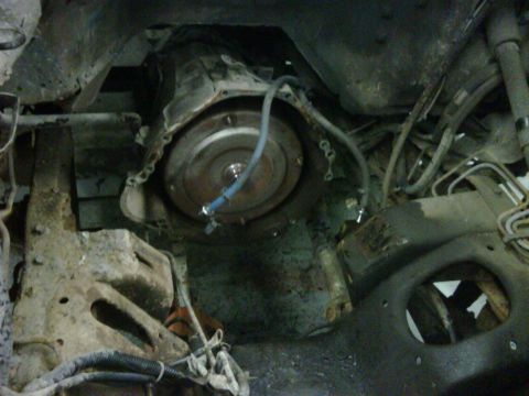 1996 Ford Bronco - Close-up of vehicle transmission and frame components, likely during repair or removal.