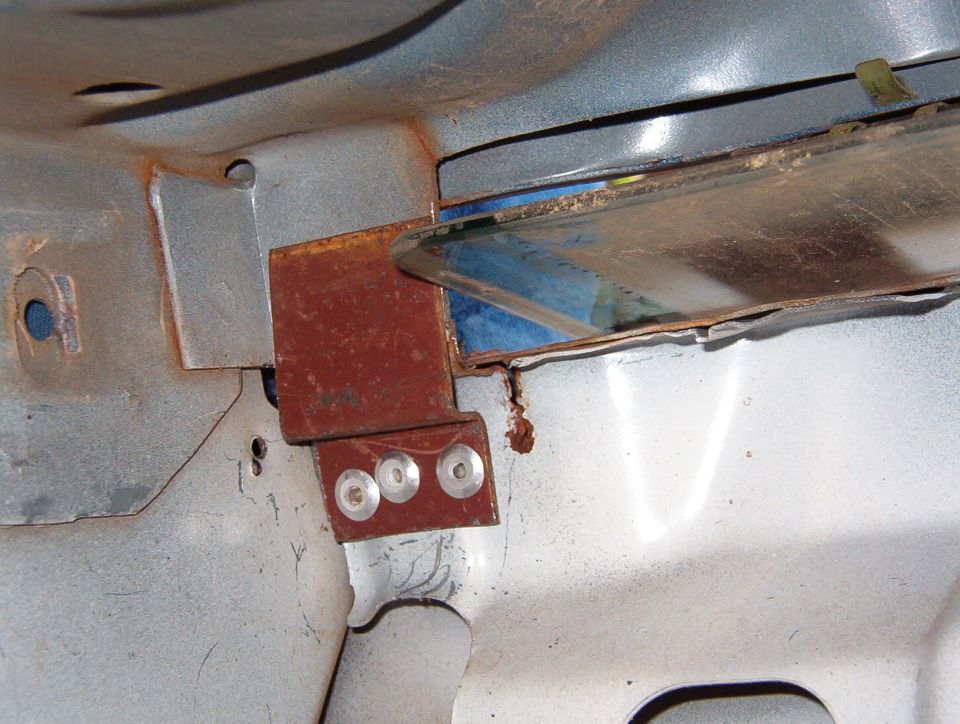 Using the predrilled holes as a guide, I installed three 3/16" rivets.  The reinforcement where the brace rests isn't flat, but it should still work.  It would be better to scuff everything to bare metal & add panel adhesive (like [url=http://www.supermotors.net/registry/2742/21197]the rain gutter TSB[/url] or JBWeld).

I'd prefer to use steel rivets, but I didn't have any handy.