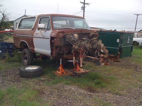 1978 Ford Bronco - This 1978 Ford Bronco is undergoing repairs with its engine exposed and front end elevated.