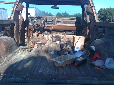 1978 Ford Bronco - The interior of a 1978 Ford Bronco shows signs of disassembly and disarray.