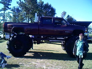 1990 Ford Bronco - This heavily modified truck features massive tires and a significantly raised chassis.